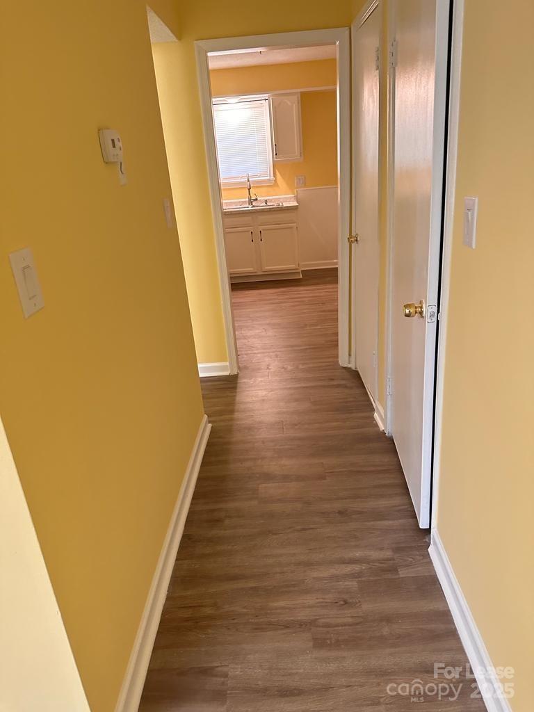 5808 Hunting Ridge Lane, Unit A Charlotte, NC 28212 - Photo 14 of 18 a view of a hallway with wooden floor