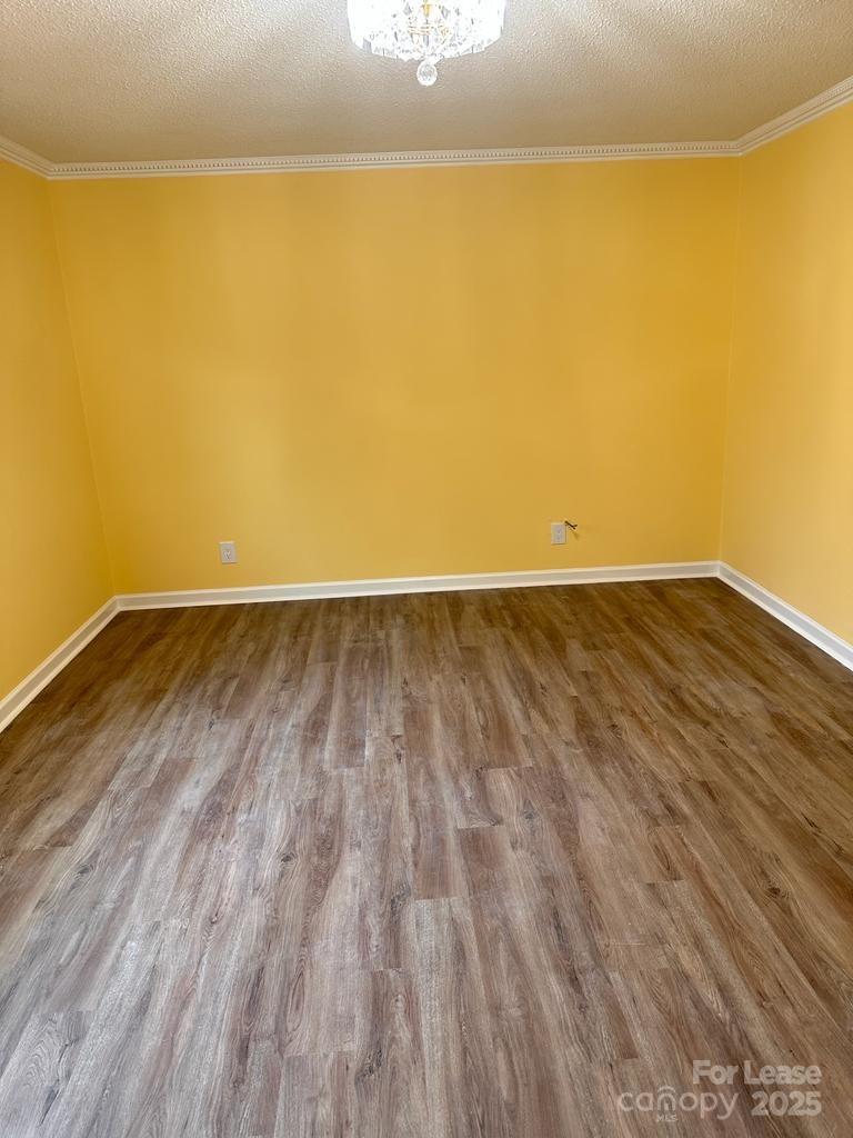 5808 Hunting Ridge Lane, Unit A Charlotte, NC 28212 - Photo 15 of 18 a view of an empty room with wooden floor and a window