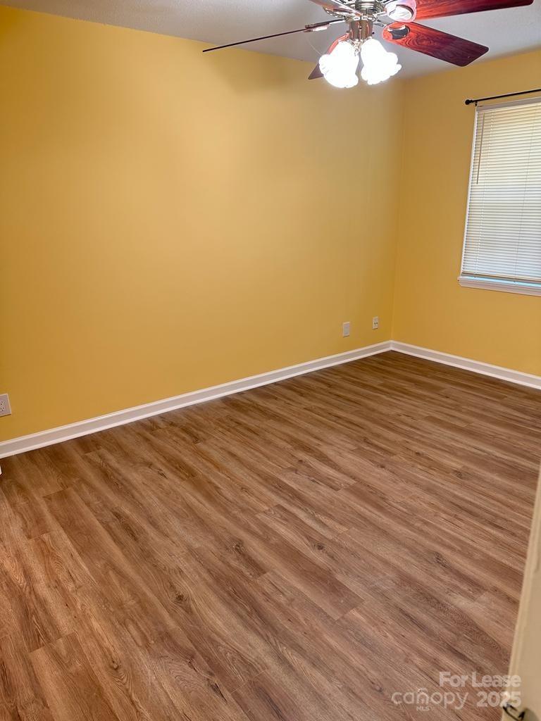 5808 Hunting Ridge Lane, Unit A Charlotte, NC 28212 - Photo 17 of 18 a view of empty room with wooden floor and fan