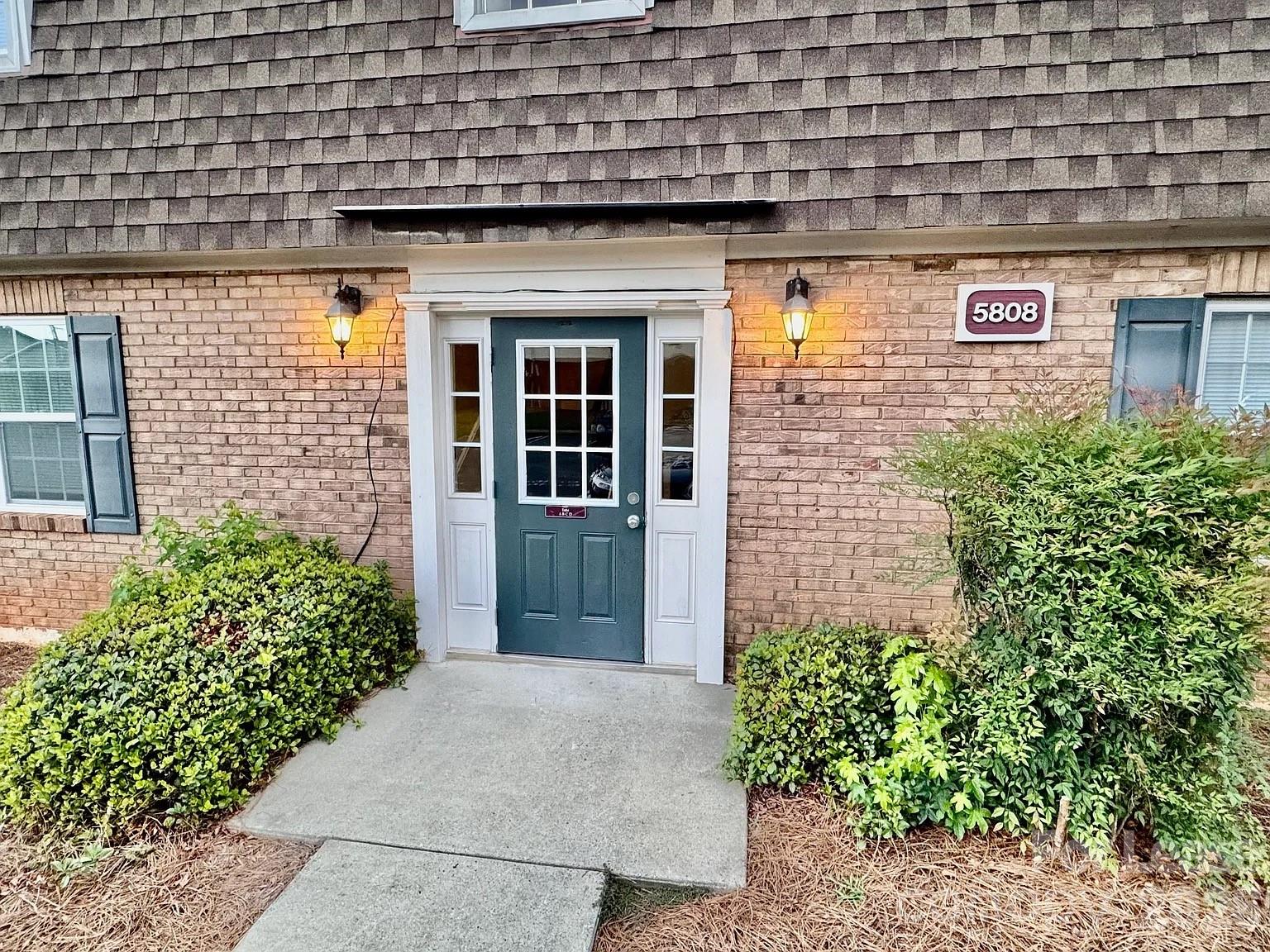 5808 Hunting Ridge Lane, Unit A Charlotte, NC 28212 - Photo 2 of 7 a view of a brick house with plants