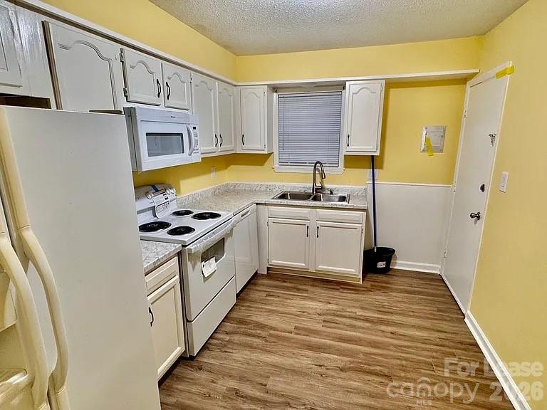 5808 Hunting Ridge Lane, Unit A Charlotte, NC 28212 - Photo 5 of 7 a kitchen with a sink stove and cabinets