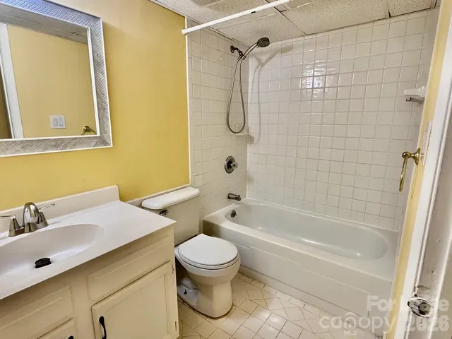 a bathroom with a toilet sink and shower