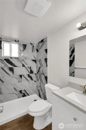 a bathroom with a sink toilet and shower