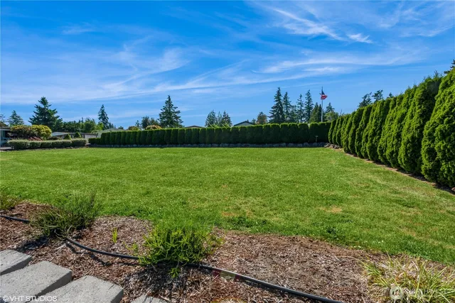 a view of a patio with chairs and a table