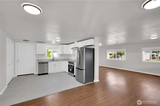 a kitchen with a refrigerator and a sink
