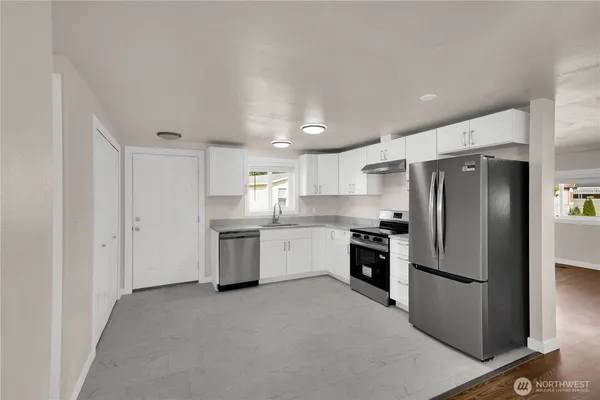 a kitchen with a refrigerator sink and stainless steel appliances