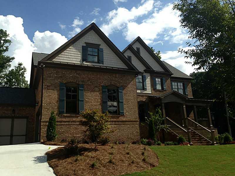 Exterior Front. Beautiful Brick and Shake Elevation with Front Porch and 3 Car Garage