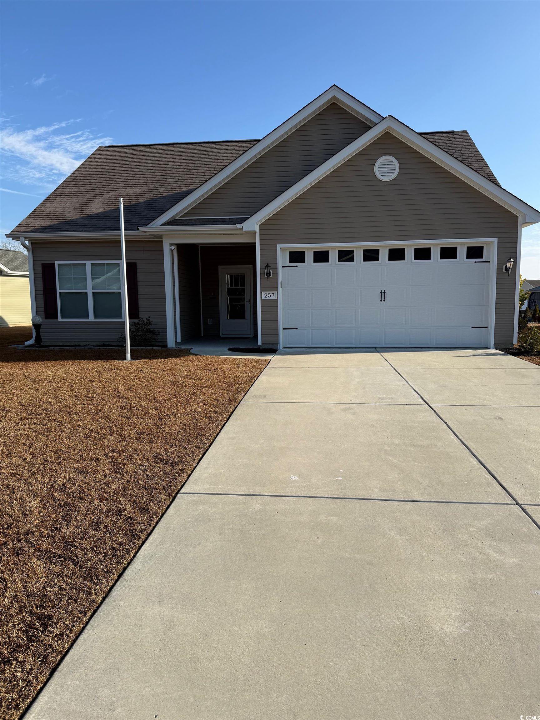 Ranch-style house with a porch, a garage, concrete driveway, and a shingled roof