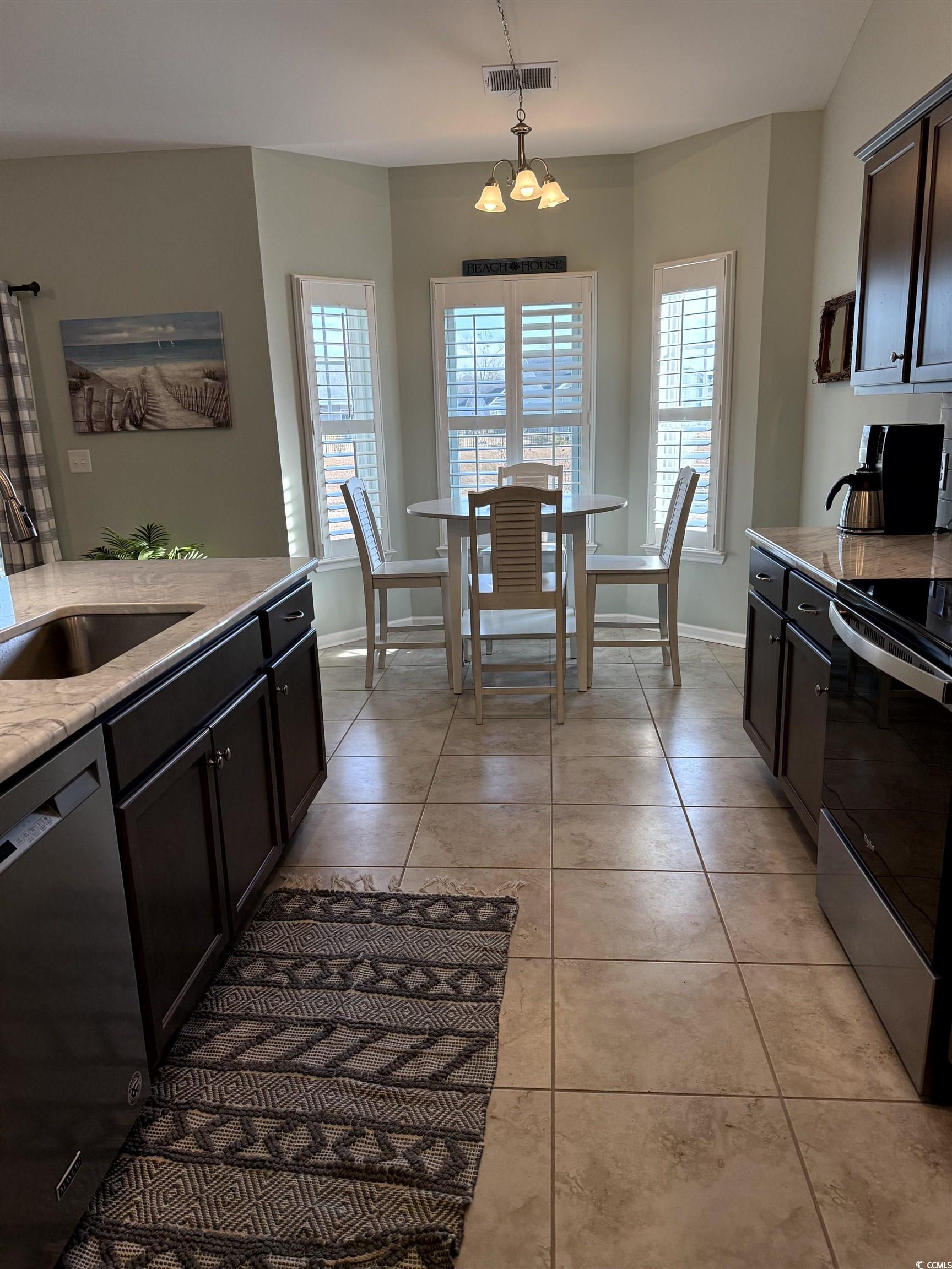 257 Maiden's Choice Drive Conway, SC 29527 - Photo 11 of 29 Kitchen with appliances with stainless steel finishes, light stone countertops, healthy amount of natural light, and decorative light fixtures