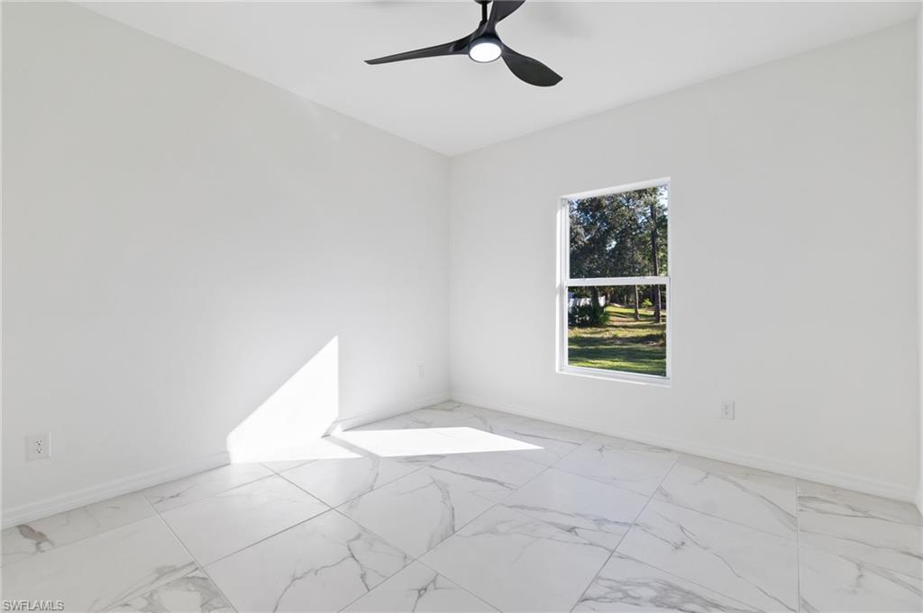 3707 Sunset Road Lehigh Acres, FL 33971 - Photo 12 of 16 a view of an empty room with a window