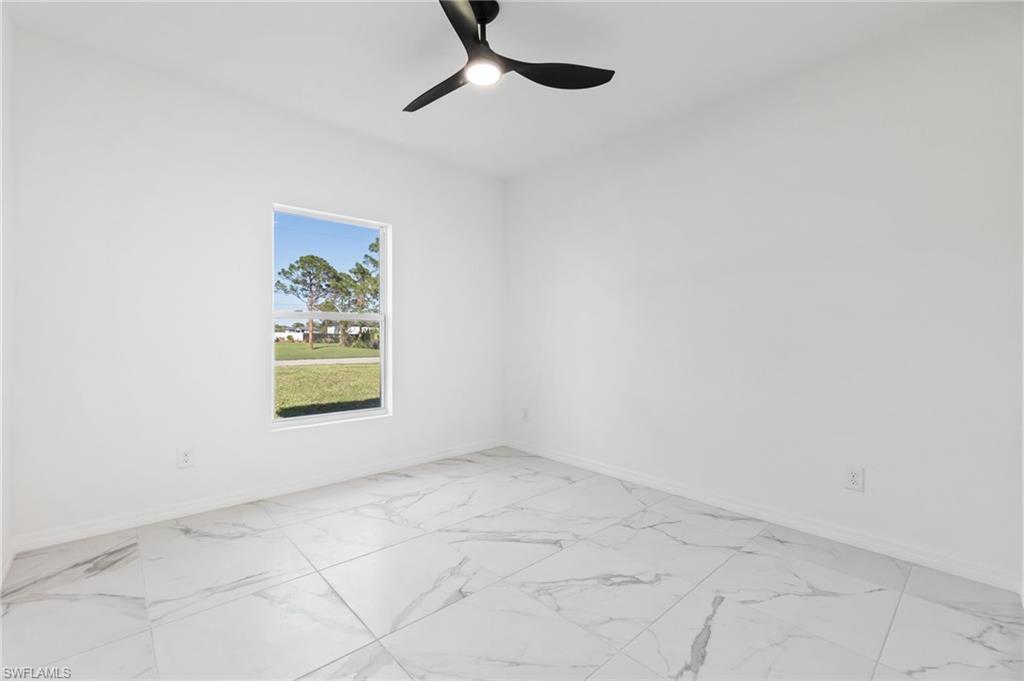 3707 Sunset Road Lehigh Acres, FL 33971 - Photo 14 of 16 an empty room with windows