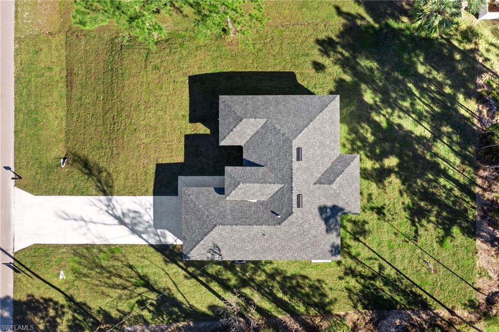 3707 Sunset Road Lehigh Acres, FL 33971 - Photo 16 of 16 an aerial view of a house with a yard