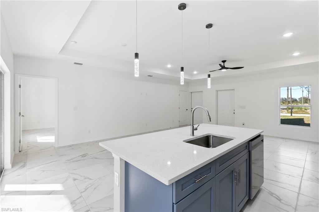 3707 Sunset Road Lehigh Acres, FL 33971 - Photo 2 of 16 a kitchen with a sink a counter space and appliances