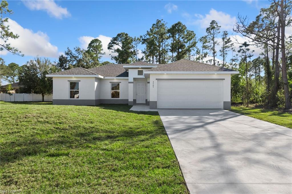 3707 Sunset Road Lehigh Acres, FL 33971 - Photo 3 of 16 front view of a house with a yard