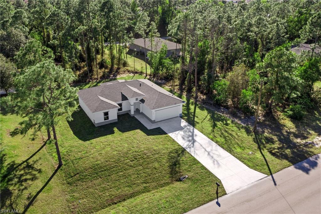 3707 Sunset Road Lehigh Acres, FL 33971 - Photo 4 of 16 an aerial view of a house with a yard