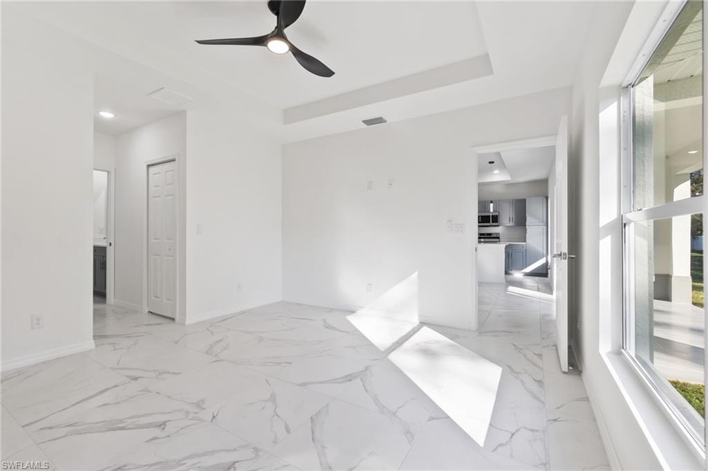 3707 Sunset Road Lehigh Acres, FL 33971 - Photo 7 of 16 a view of livingroom with hardwood floor and a ceiling fan