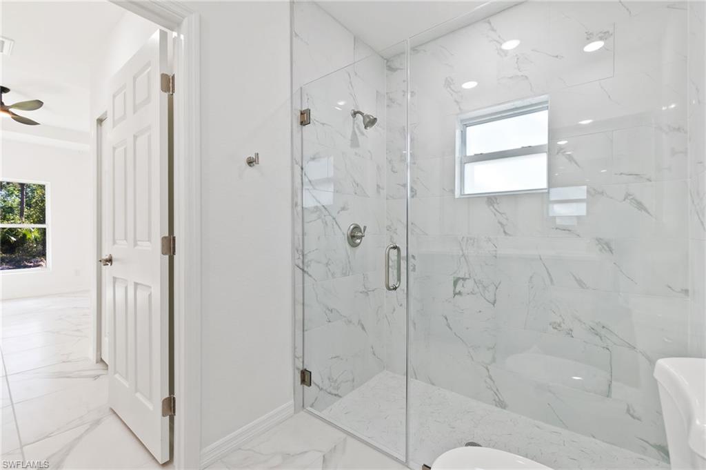 3707 Sunset Road Lehigh Acres, FL 33971 - Photo 9 of 16 a bathroom with a shower