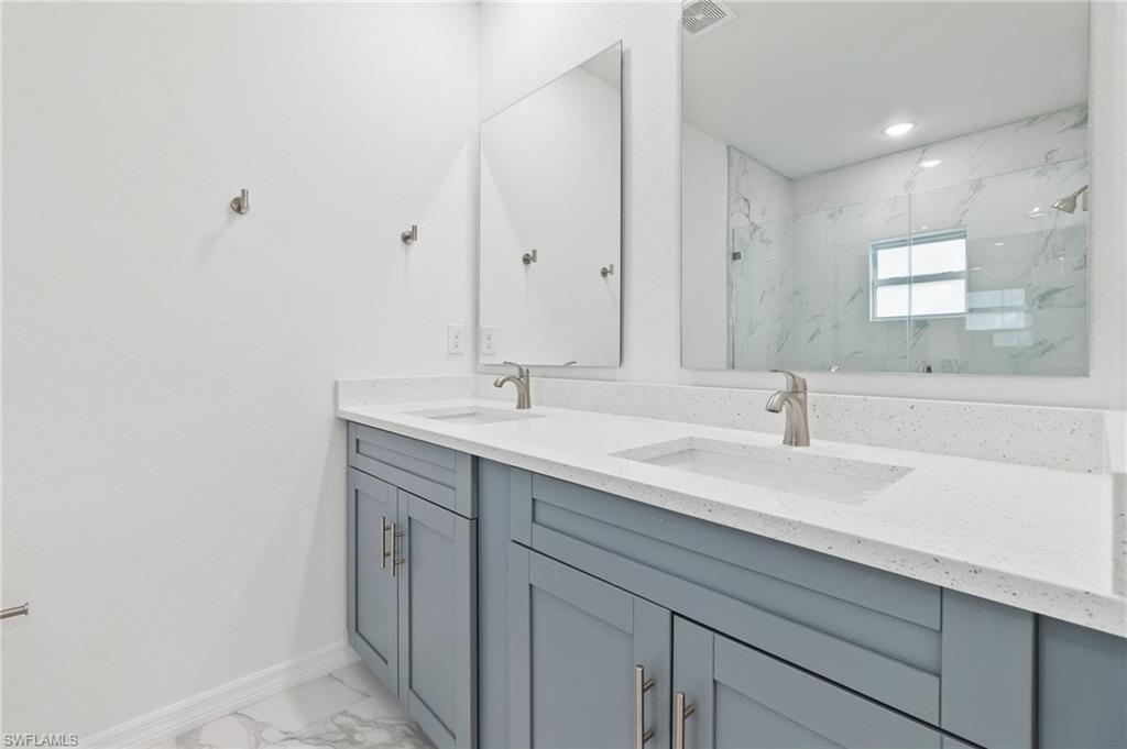 3707 Sunset Road Lehigh Acres, FL 33971 - Photo 10 of 16 a bathroom with a sink and a mirror