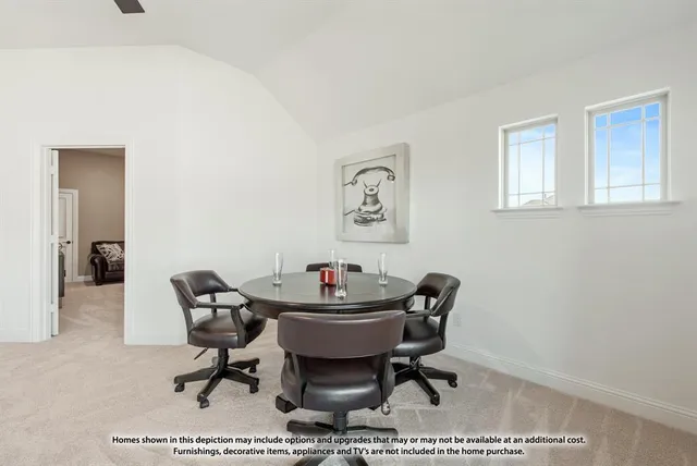 a work room with furniture a rug and a window