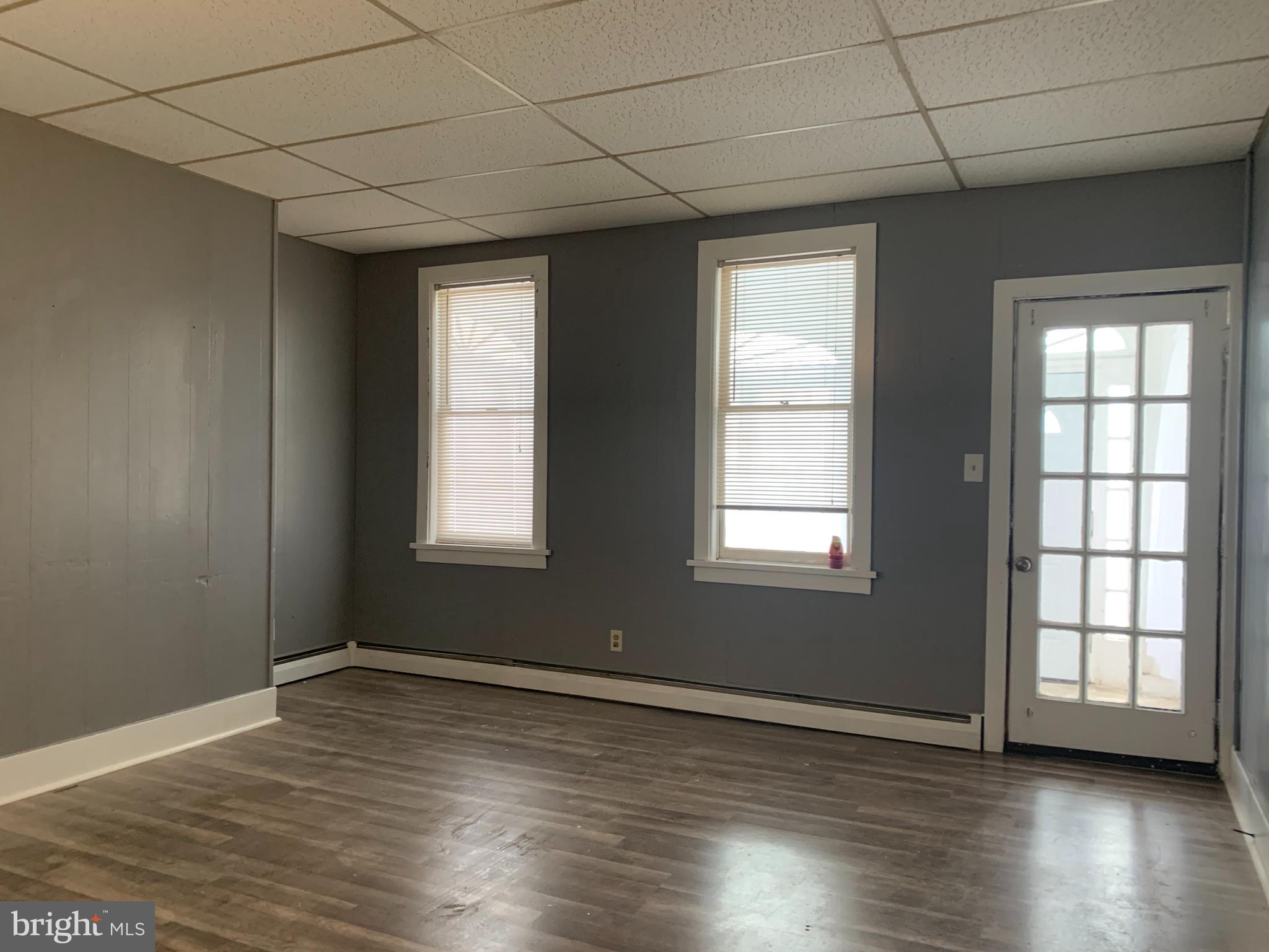 822 Columbus Road Burlington, NJ 08016 - Photo 10 of 32 a view of an empty room with wooden floor and a window