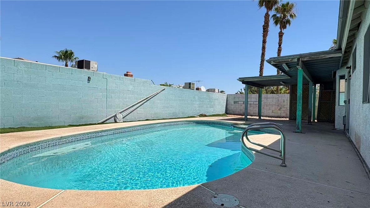 4325 Newcastle Road Las Vegas, NV 89103 - Photo 18 of 18 An inviting backyard oasis awaits, complete with a refreshing swimming pool and a covered patio for outdoor enjoyment.