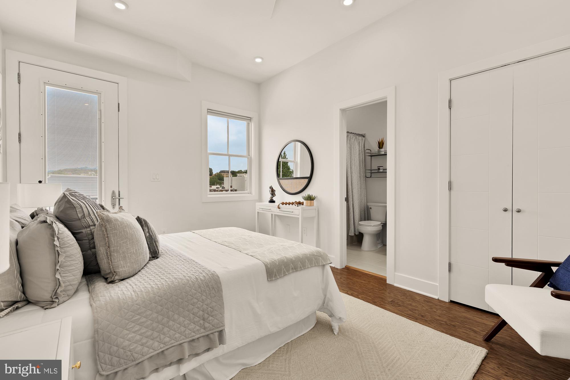 2000 D Street Northeast, Unit 6 Washington, DC 20002 - Photo 12 of 30 a bedroom with a bed and a large mirror