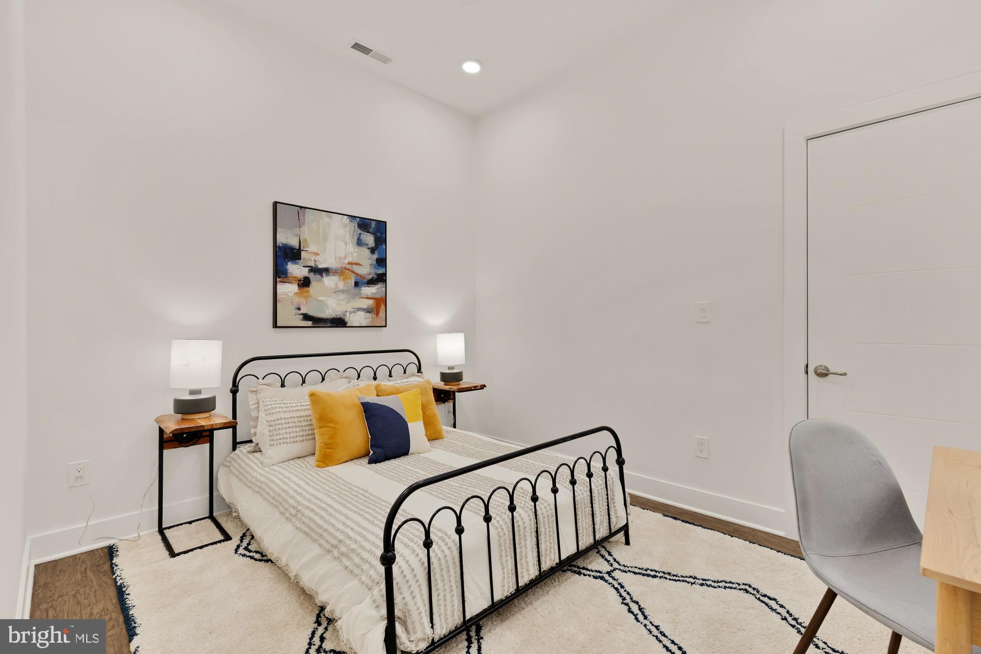 2000 D Street Northeast, Unit 6 Washington, DC 20002 - Photo 16 of 30 a bedroom with a bed and a chair