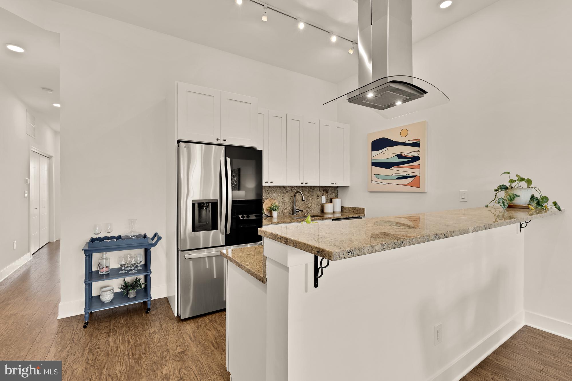 2000 D Street Northeast, Unit 6 Washington, DC 20002 - Photo 6 of 30 a kitchen with stainless steel appliances granite countertop a sink a stove and a refrigerator