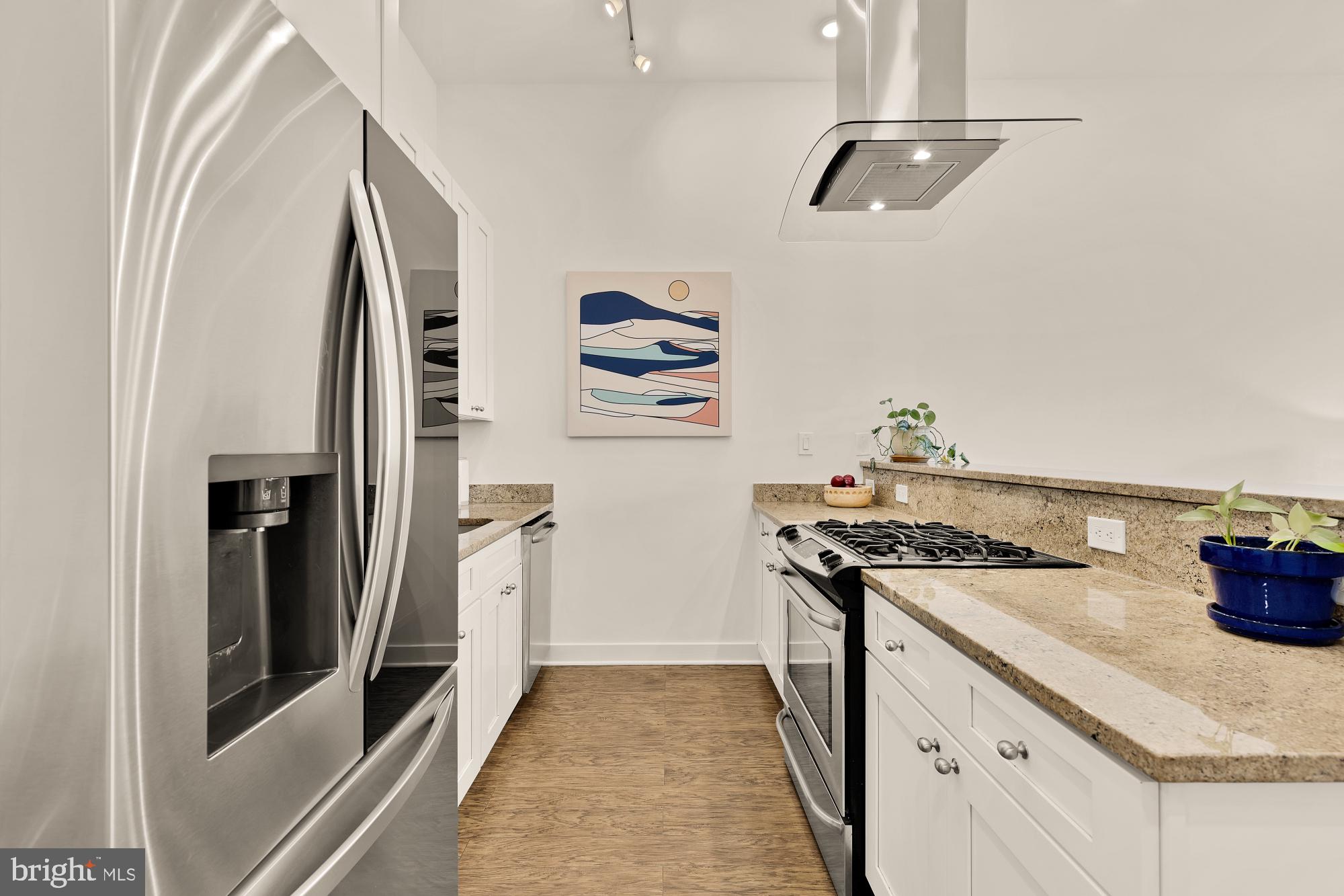2000 D Street Northeast, Unit 6 Washington, DC 20002 - Photo 7 of 30 a kitchen with stainless steel appliances granite countertop a refrigerator and a stove
