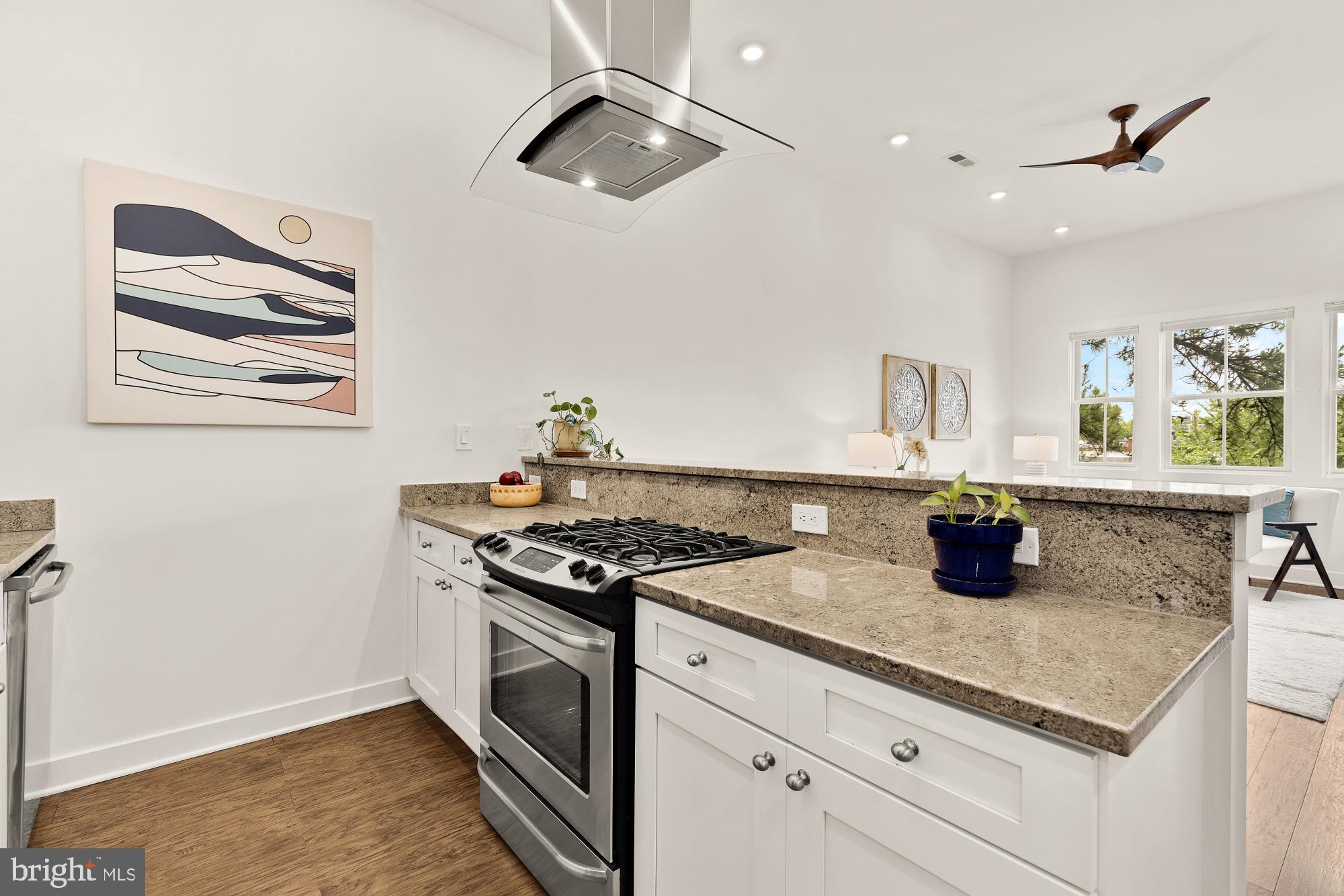 2000 D Street Northeast, Unit 6 Washington, DC 20002 - Photo 8 of 30 a kitchen with a stove and a wooden floor