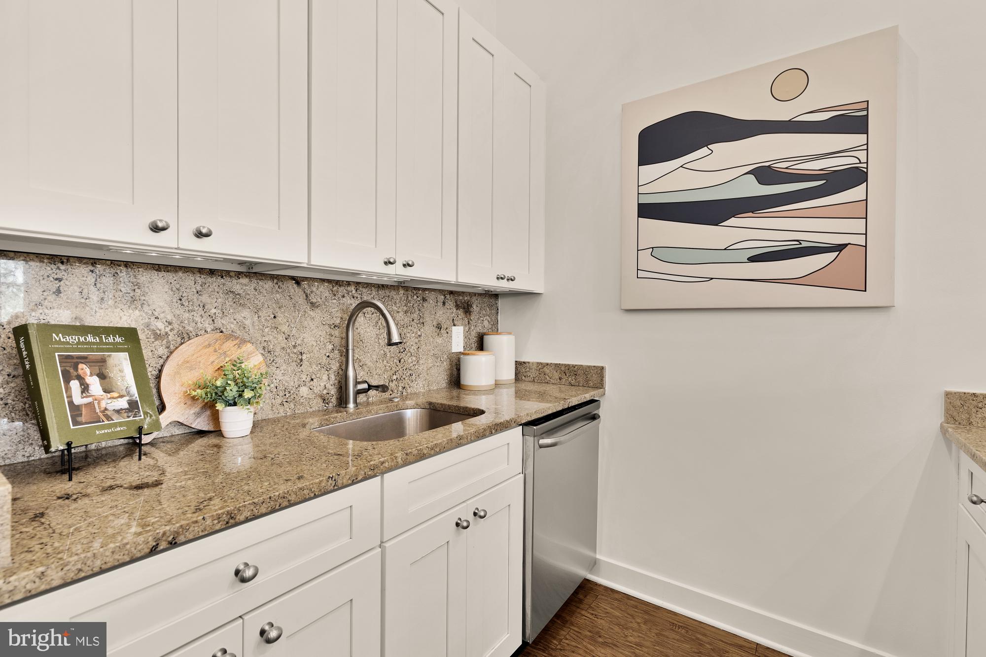 2000 D Street Northeast, Unit 6 Washington, DC 20002 - Photo 9 of 30 a kitchen with granite countertop white cabinets and sink