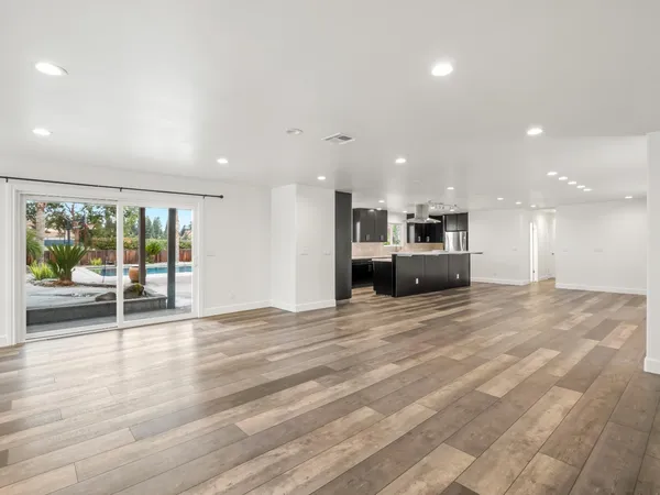 a kitchen with stainless steel appliances a sink a stove and a refrigerator