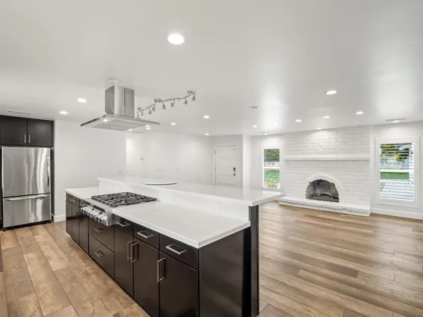 a view of a kitchen with a sink and stainless steel appliances