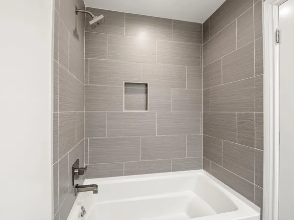 an empty room with a window and ceiling fan