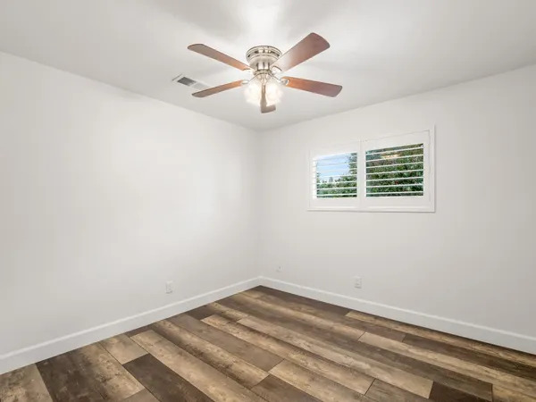 an empty room with a ceiling fan