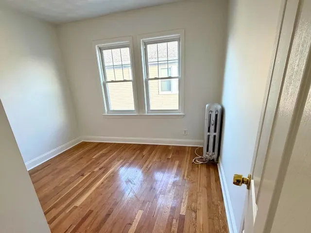 a view of a room with wooden floor and sink