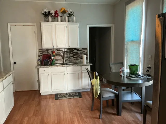 a dining room with furniture and wooden floor