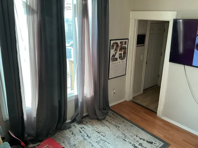 a view of a hallway with wooden floor