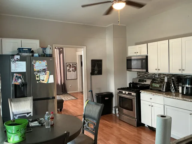 a living room with furniture a flat screen tv and kitchen view