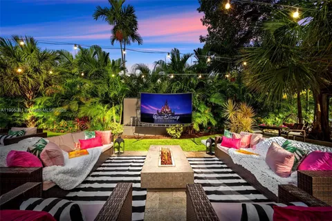 a view of a patio with table and chairs potted plants and tree