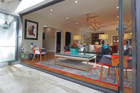 a kitchen with stainless steel appliances granite countertop a refrigerator a stove and a wooden floors