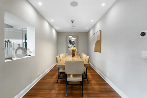 a living room with furniture a chandelier and a dining table