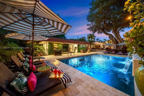 a backyard of a house with a swing chair and entertaining space