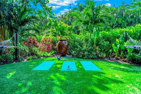 a view of a patio with table and chairs under an umbrella