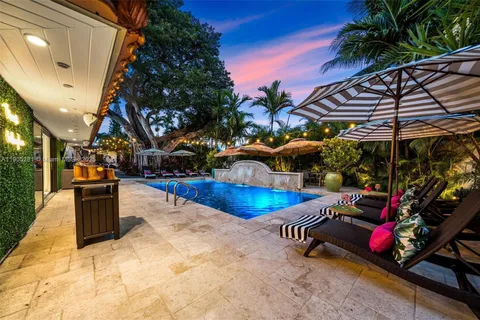 a view of a backyard with a patio and a tub