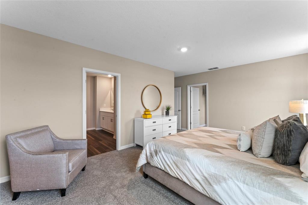 1812 Three Bars Road Kissimmee, FL 34744 - Photo 15 of 64 a bedroom with a bed and a chandelier