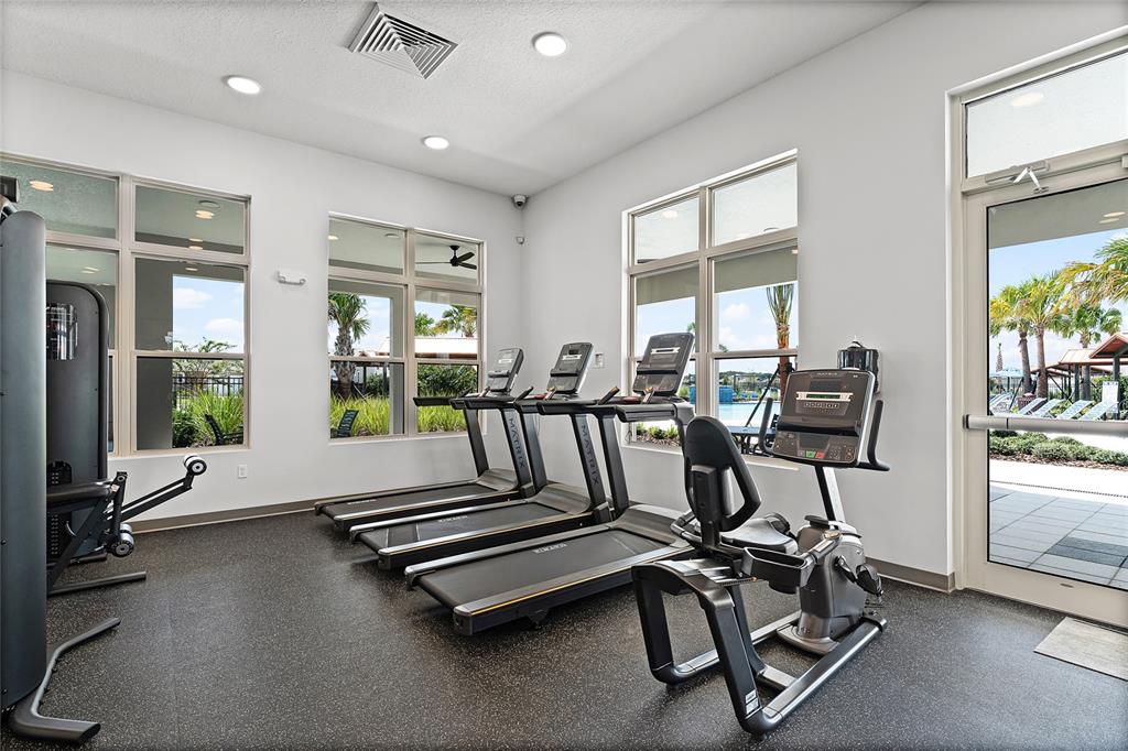 1812 Three Bars Road Kissimmee, FL 34744 - Photo 42 of 64 a room with gym equipment and large windows