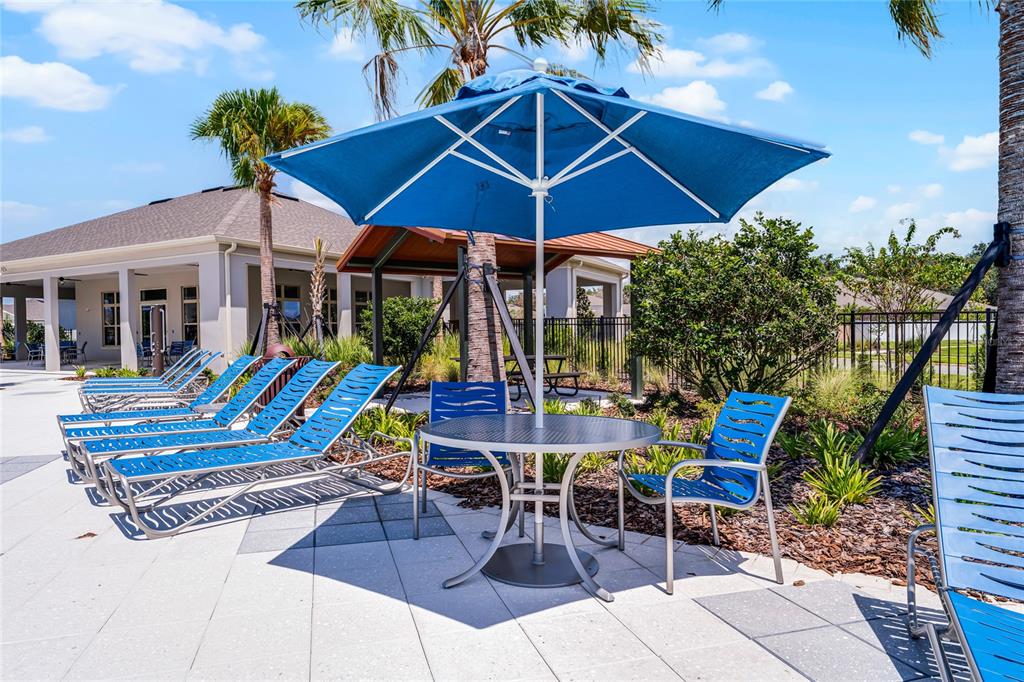 1812 Three Bars Road Kissimmee, FL 34744 - Photo 52 of 64 a view of a patio with a table chairs and a umbrella