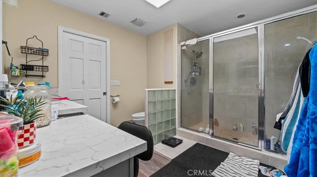 a bathroom with a tub shower and mirror
