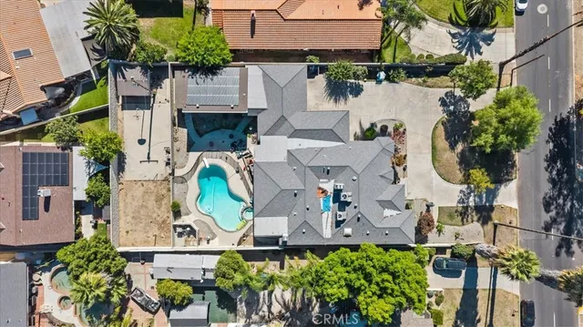 an aerial view of a house with a garden and swimming pool